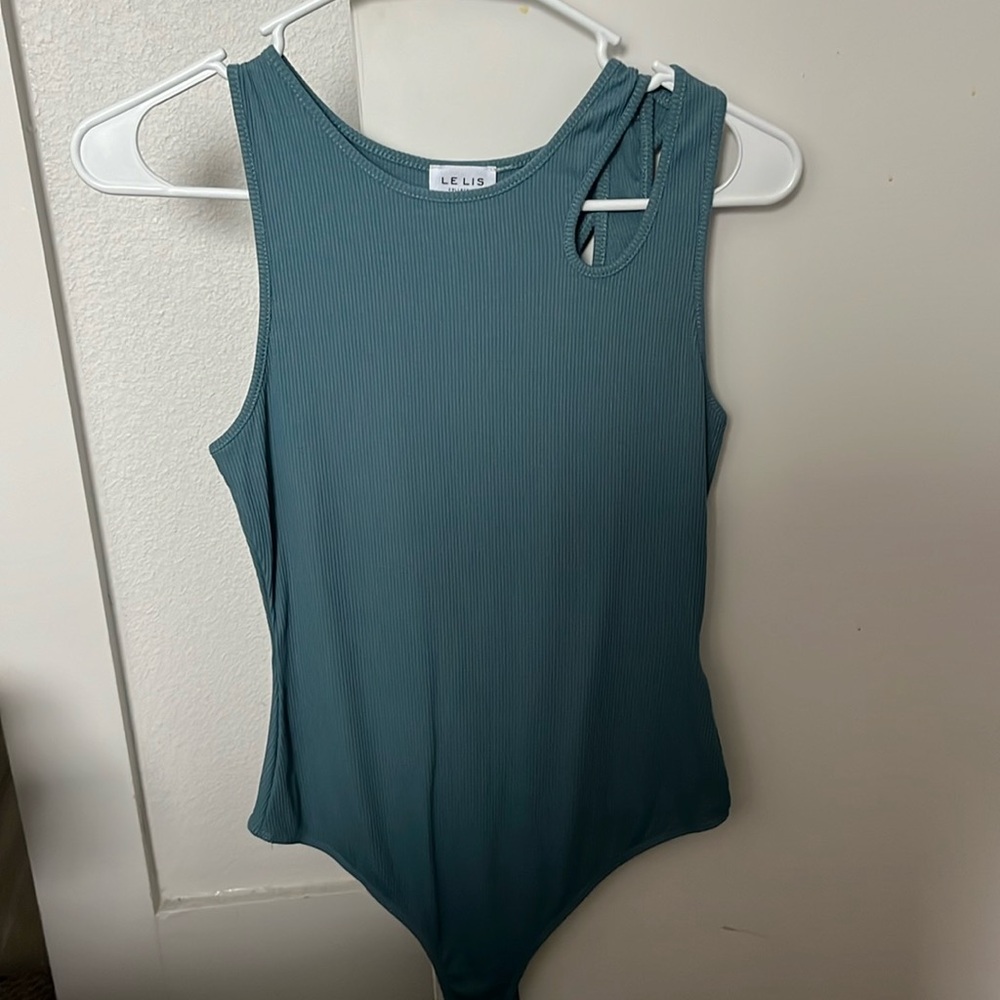 Teal bodysuit, cross on one of the shoulders